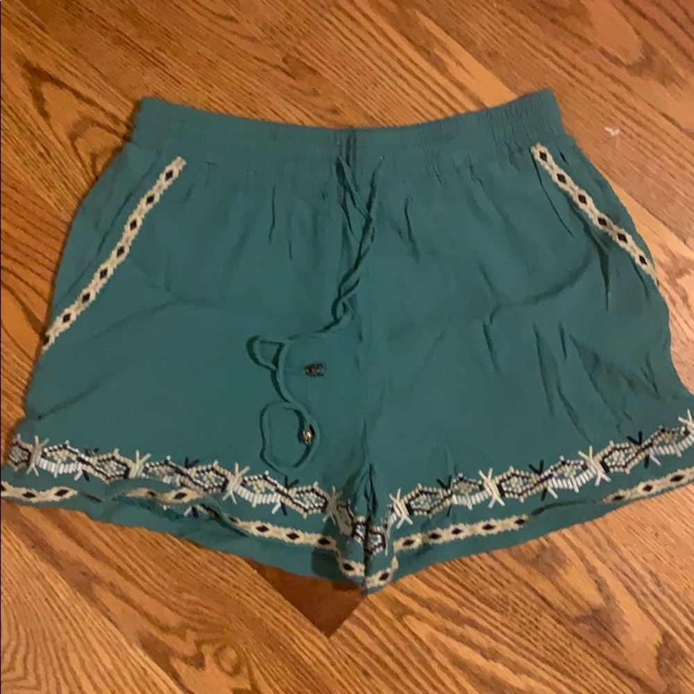 Turquoise loose fitting shorts.